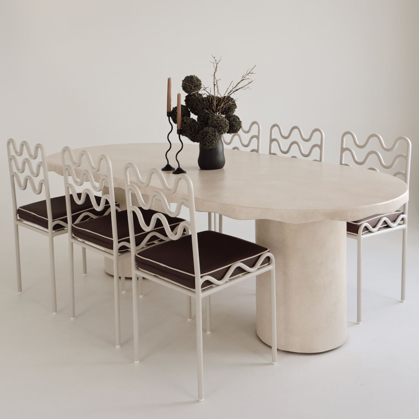 Solea dining table styled with chairs and vases