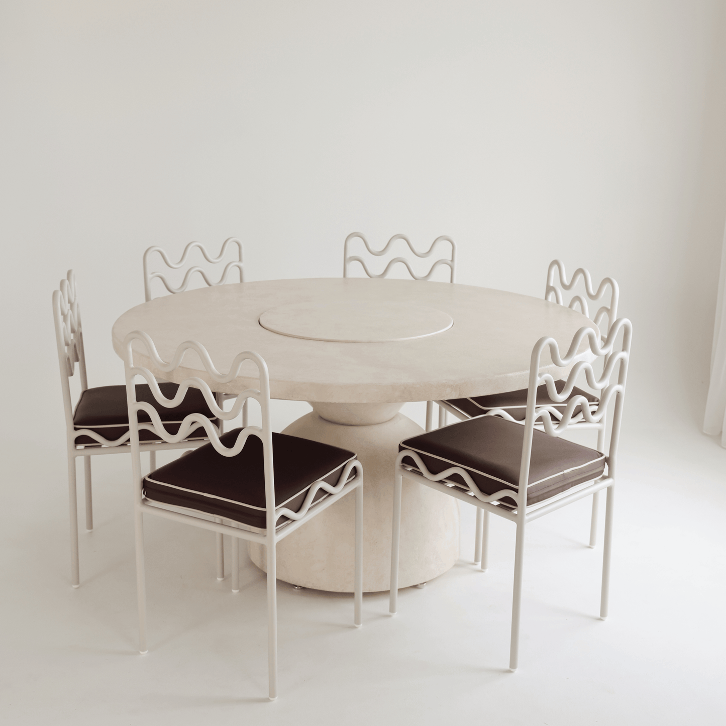 lotus round dining table styled with chairs 
