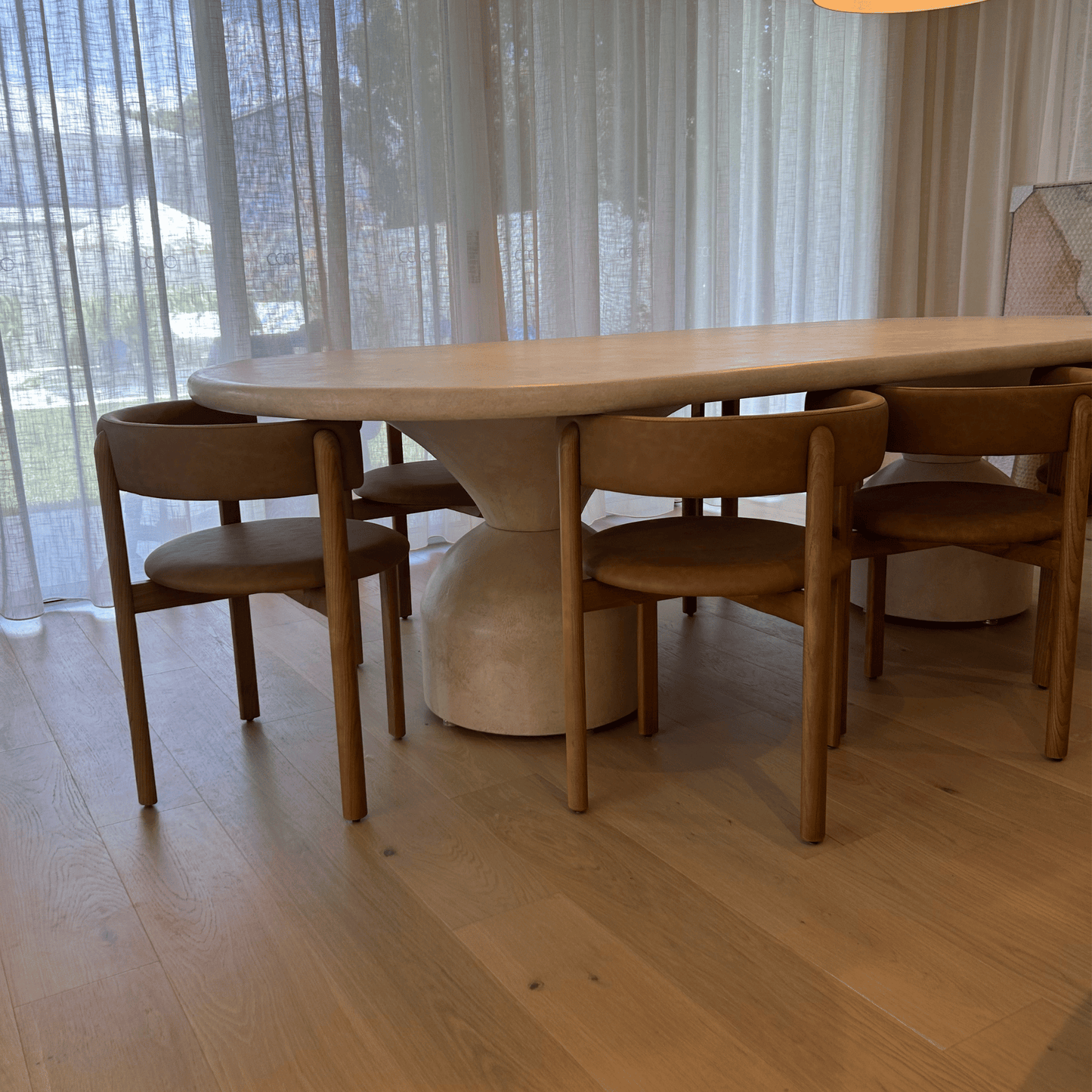 lotus dining table in sand stonewash close up of lotus leg